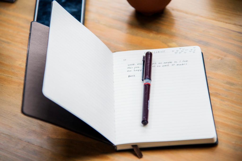 journal and a pen on a table at workshop