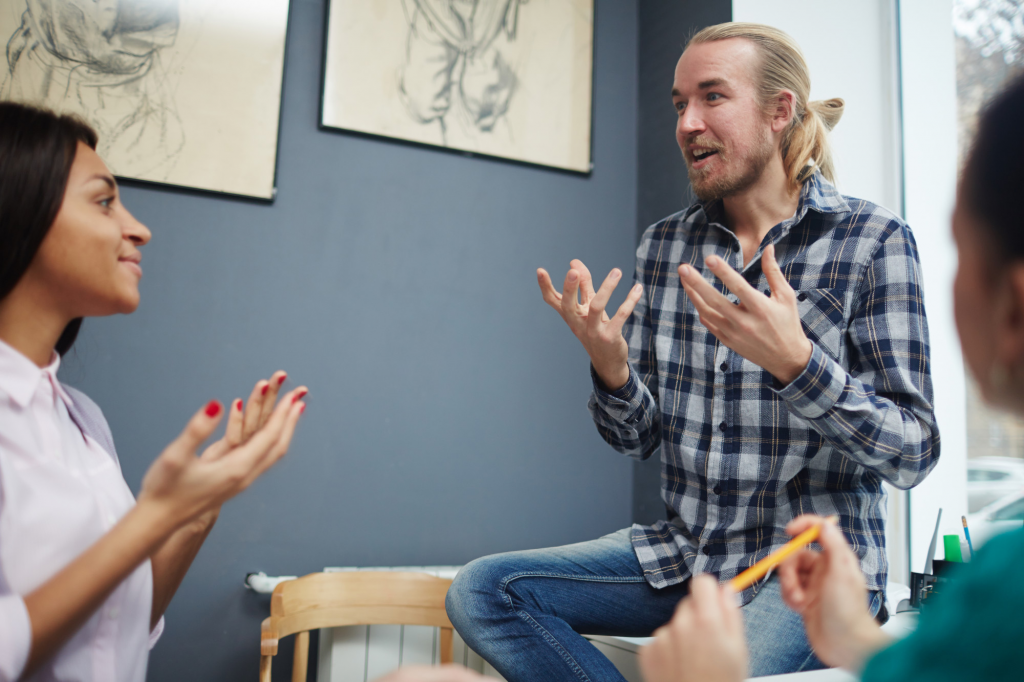 a male speaking to a small group in a voice workshop